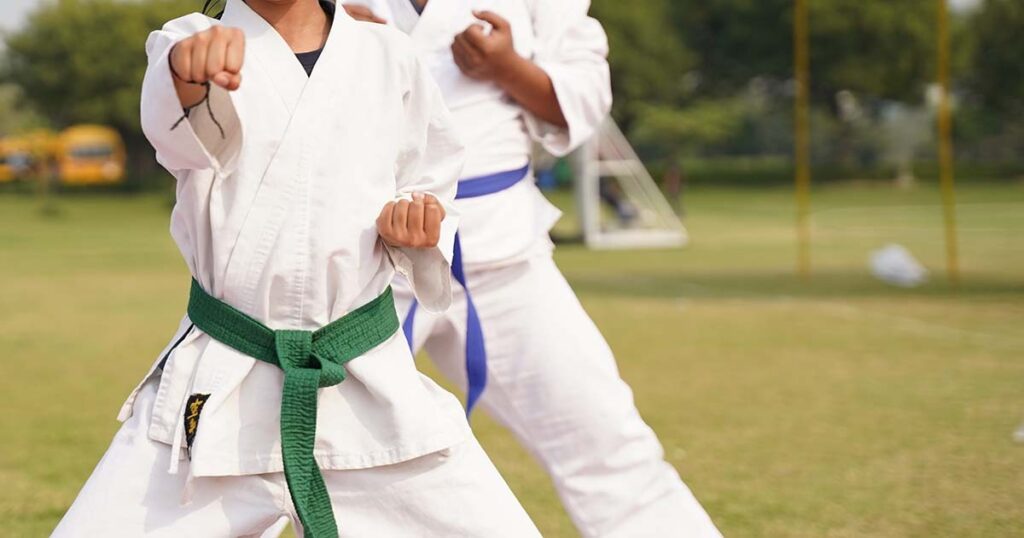 karate students practicing with colored belts