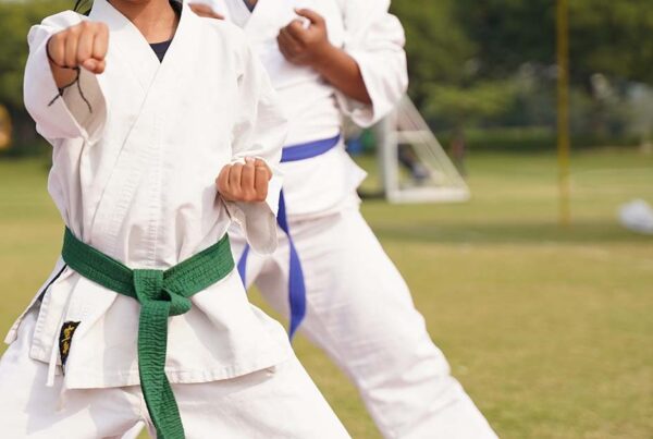 karate students practicing with colored belts