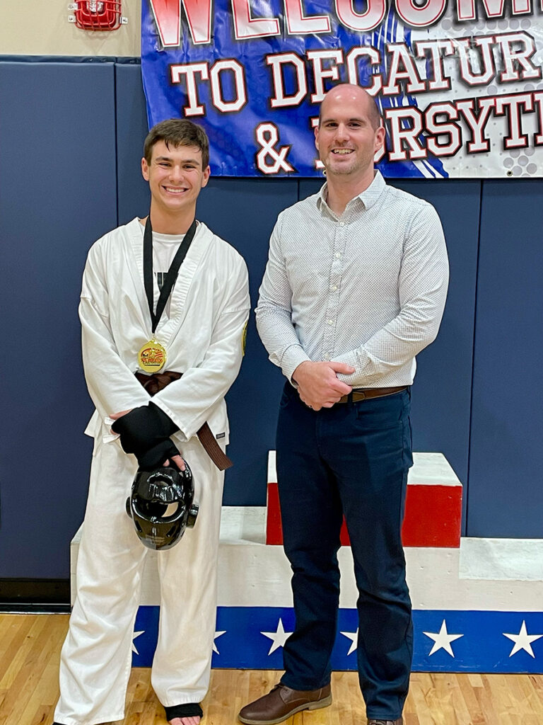 Paul Deeb poses with Sensei Adam after his 1st-place sparring victory