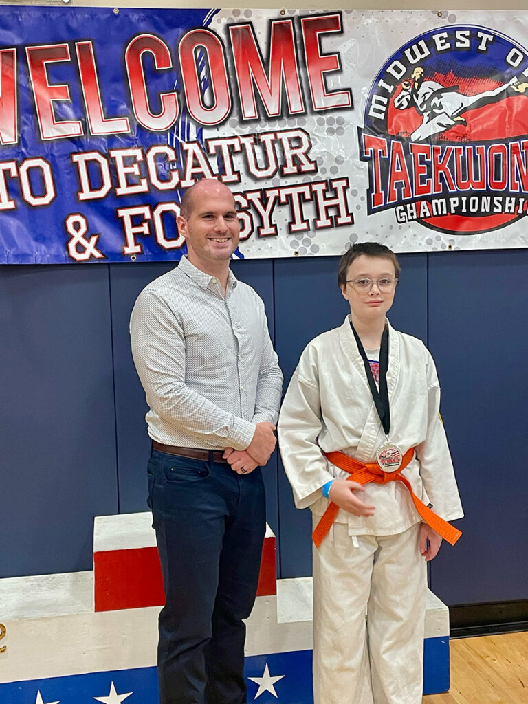 Sensei Adam poses with Corbin Cox after his 2nd-place forms victory