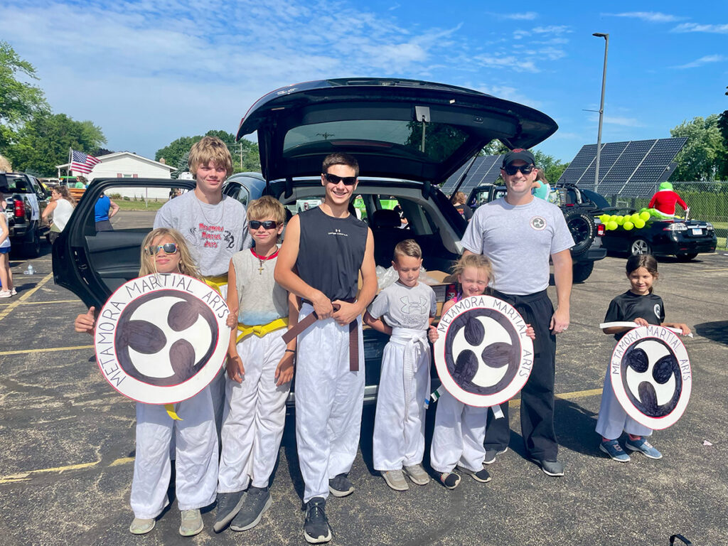 Metamora Martial Arts students and Adam Bockler pose for a picture before the 2024 Old Settlers parade