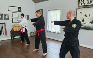 Sensei James Gifford, Hanshi, leads Naihanchi kata training with Sensei Adam and James Weider, Renshi, at the shinmeikan in Blairsville, GA