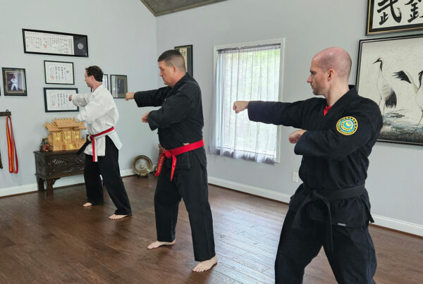 Sensei James Gifford, Hanshi, leads Naihanchi kata training with Sensei Adam and James Weider, Renshi, at the shinmeikan in Blairsville, GA