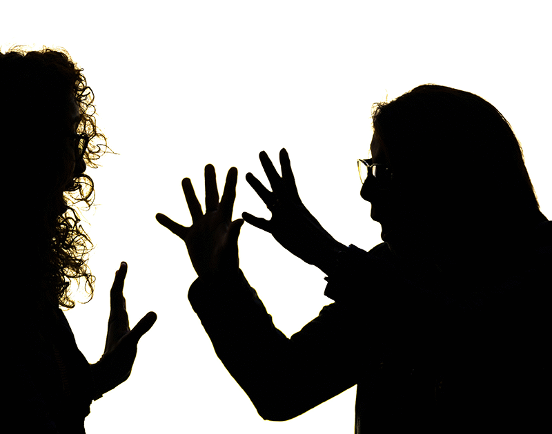 Silhouettes of people, both of whom have their hands up